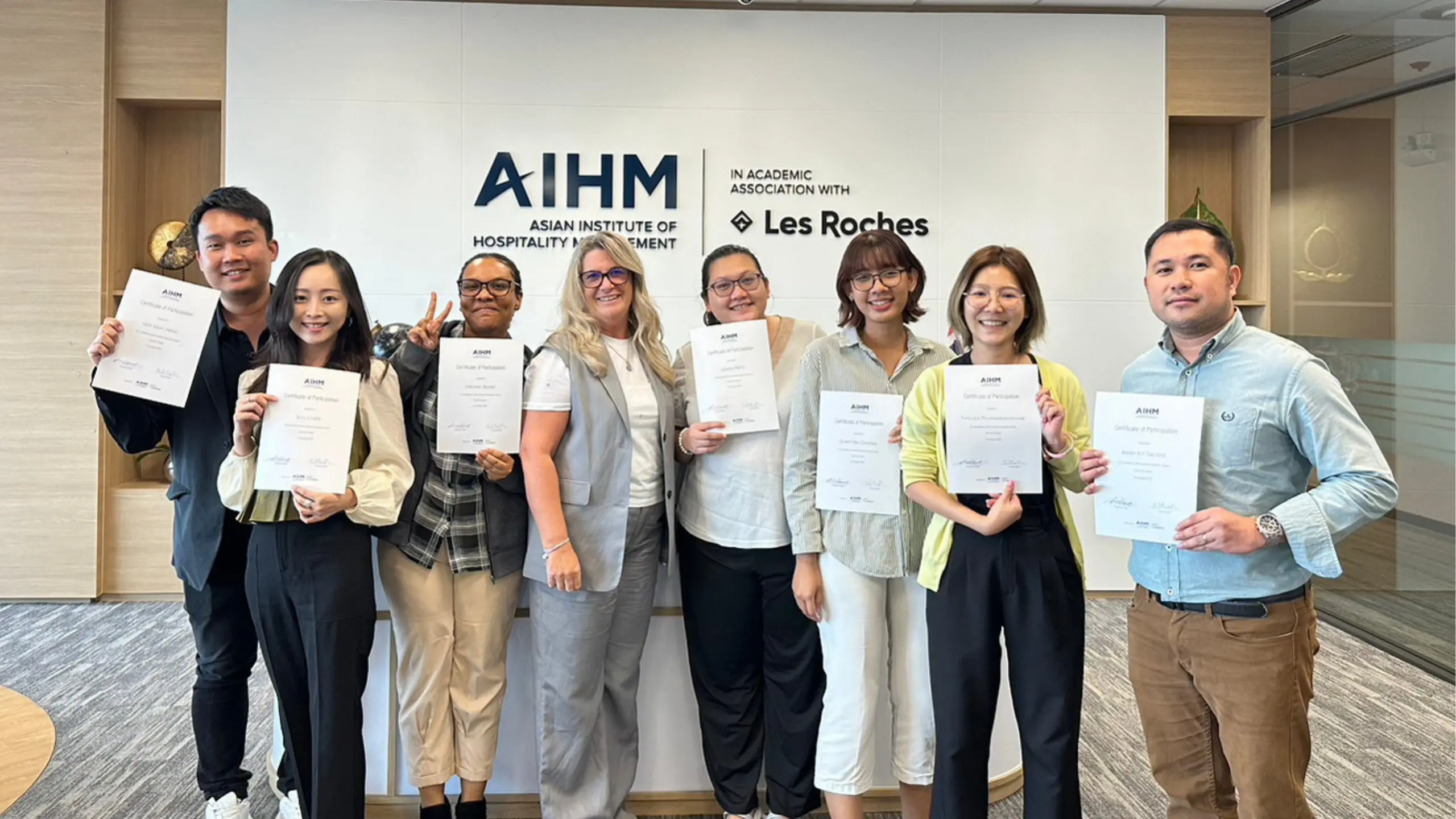 Participants holding certificates after completing Train the Trainer course at AIHM executive education programme