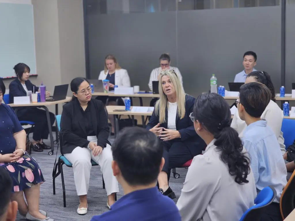 AIHM Train-the-Trainer session with hospitality professionals engaging in a leadership circle discussion, building communication, facilitation, and coaching skills through executive education.