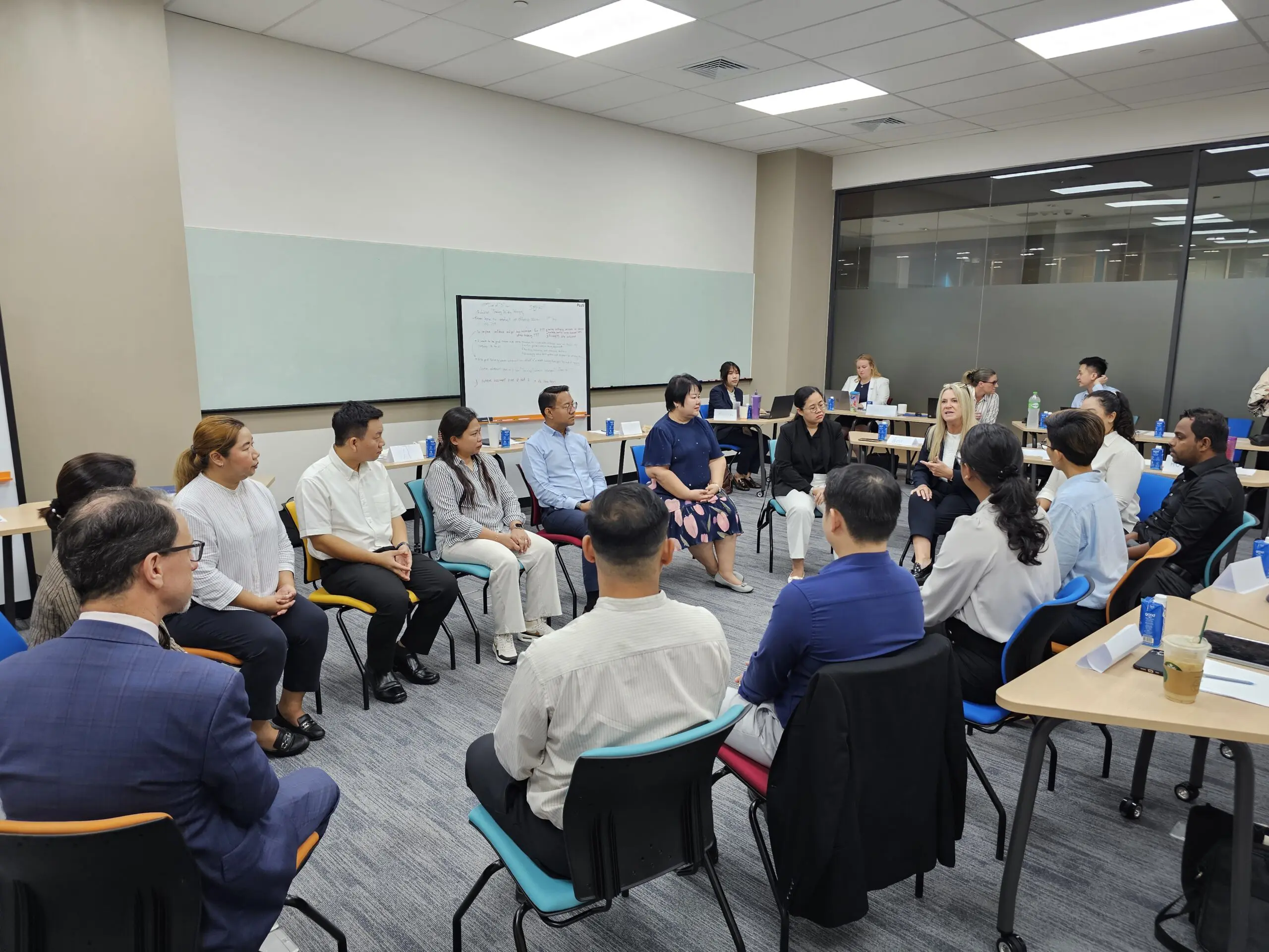 Participants in the AIHM Train-the-Trainer programme collaborating in a circle activity to develop facilitation, communication, and coaching techniques for hospitality leadership.