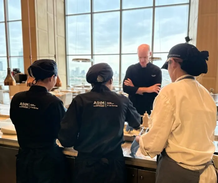 AIHM executive education participants in food and beverage management training, working with professional chef in Bangkok hospitality workshop