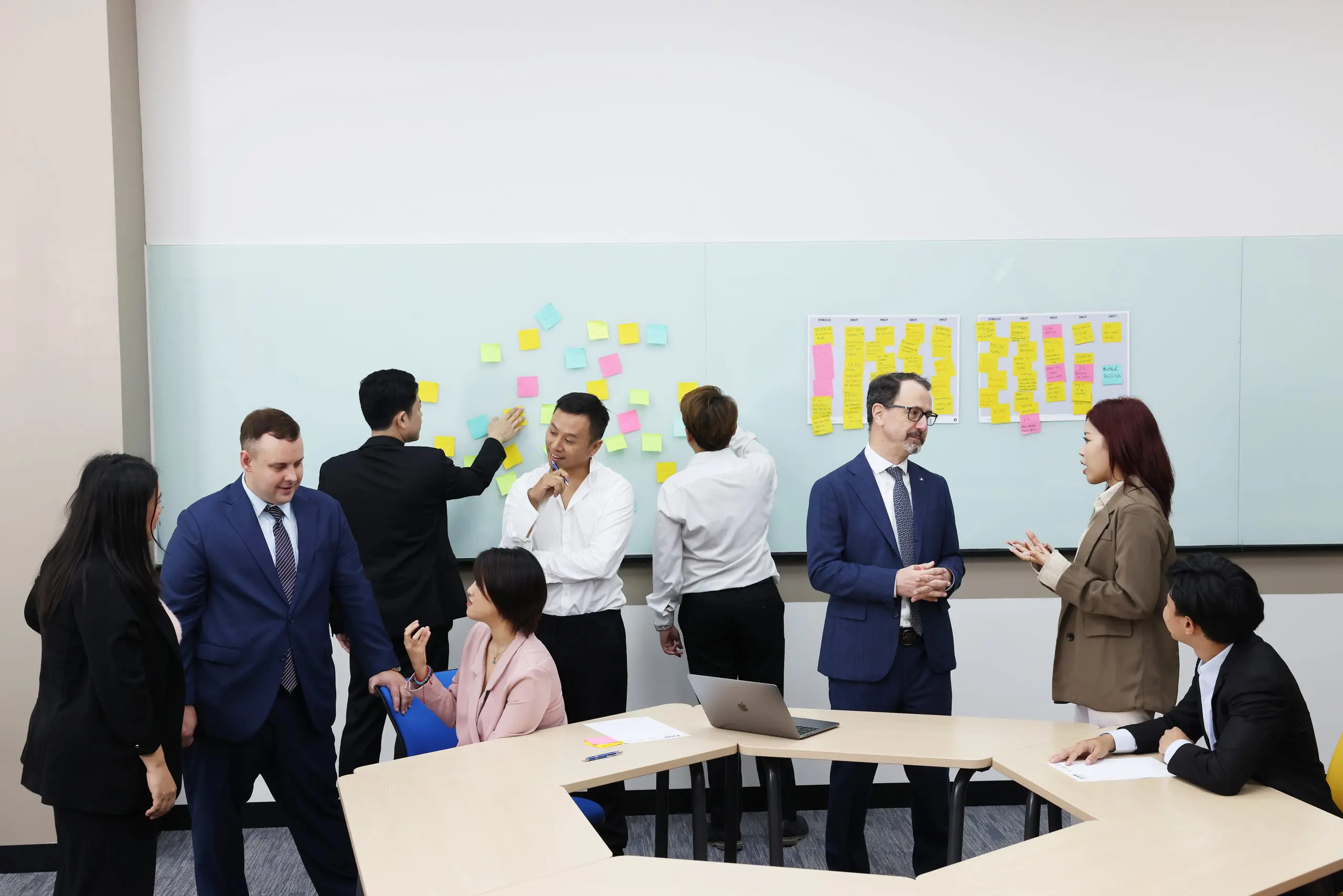 AIHM ad-hoc and custom corporate training session with professionals collaborating, brainstorming, and developing skills through interactive activities tailored to organisational needs.