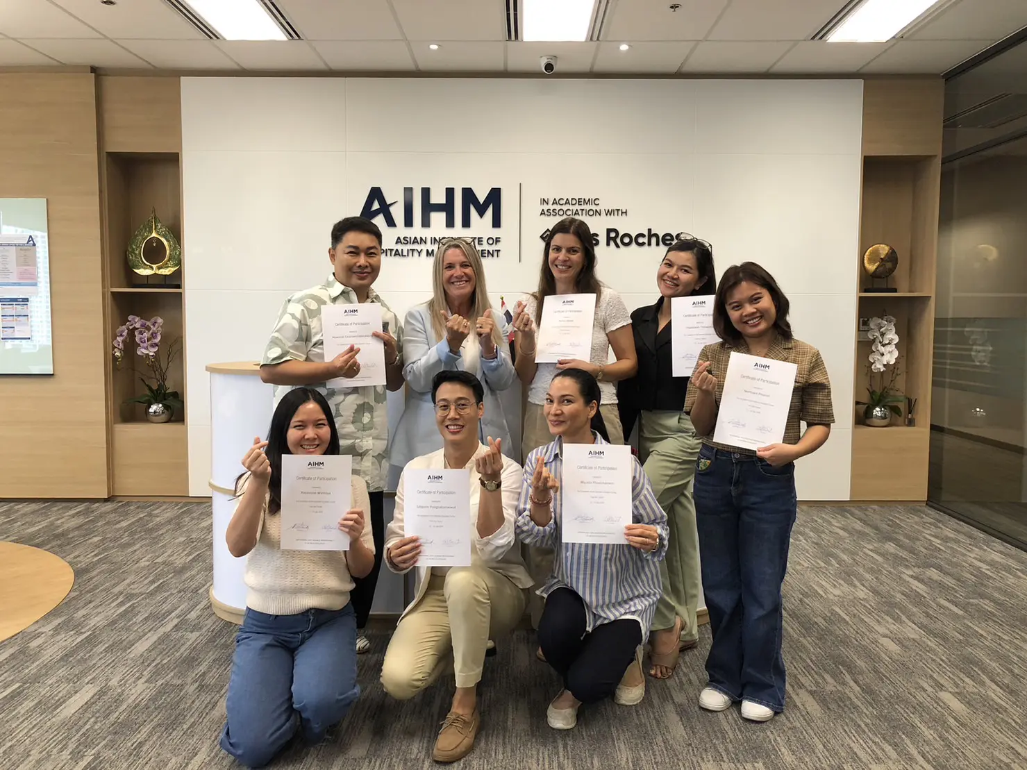 AIHM Train the Trainer programme featuring hospitality professionals receiving certificates after completing leadership, coaching, and skills-development training in Bangkok.