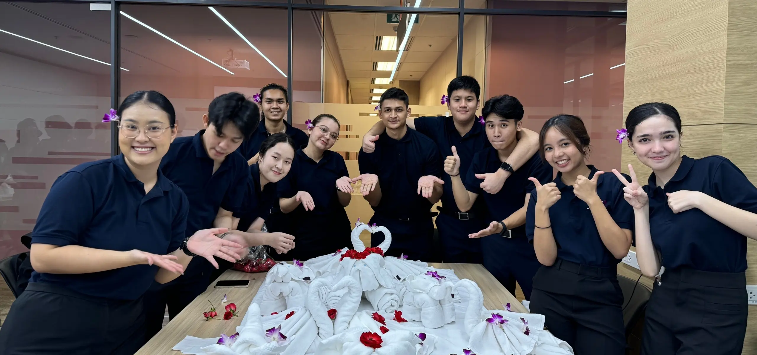 AIHM BBA hospitality management students learn housekeeping practical arts, creating towel art and room presentation skills as part of Swiss-inspired Les Roches academic training in Thailand.