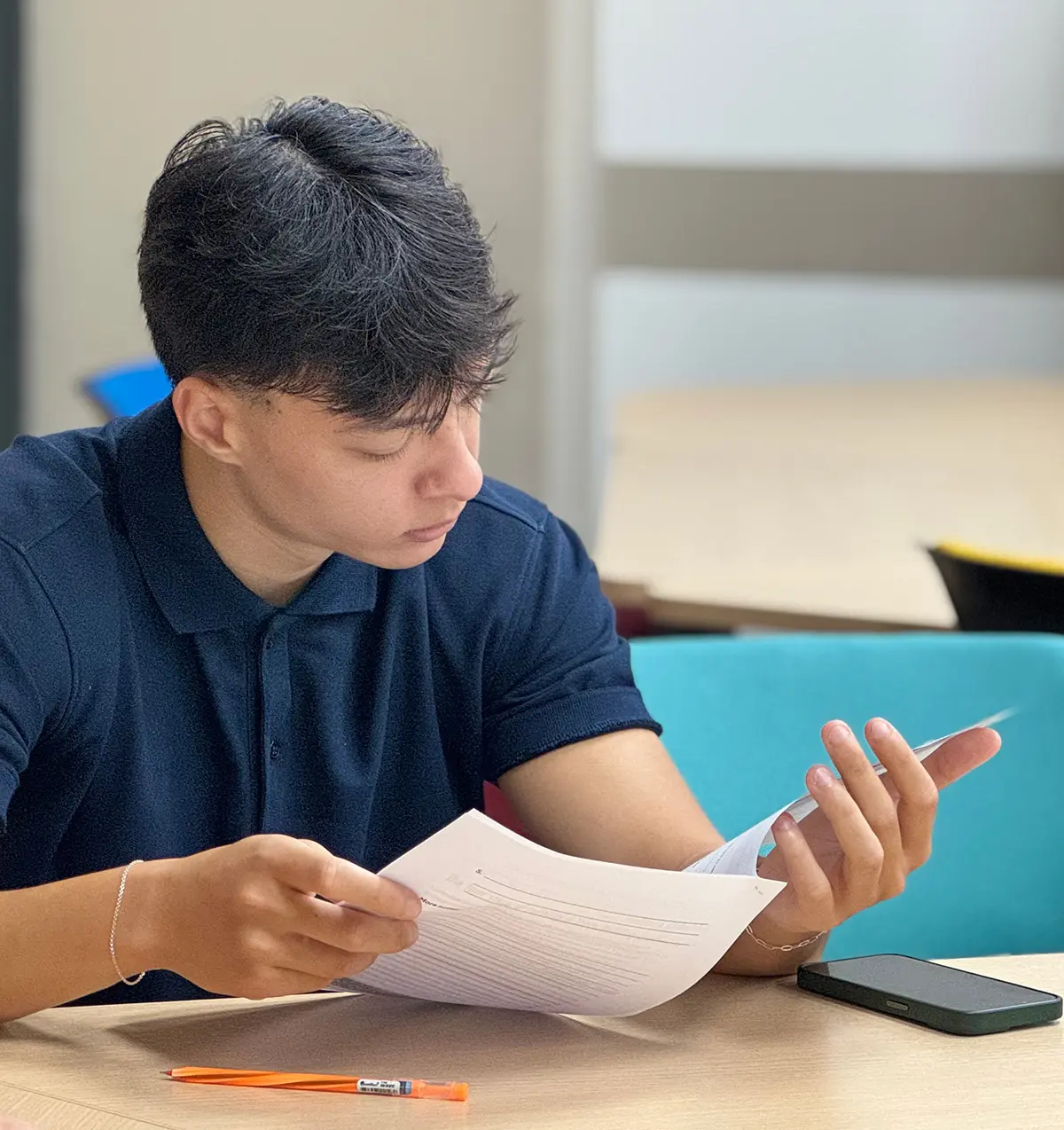 AIHM College student reviews coursework during an NCUK Foundation Year class, demonstrating focused academic study and preparation for international university pathways in Bangkok.