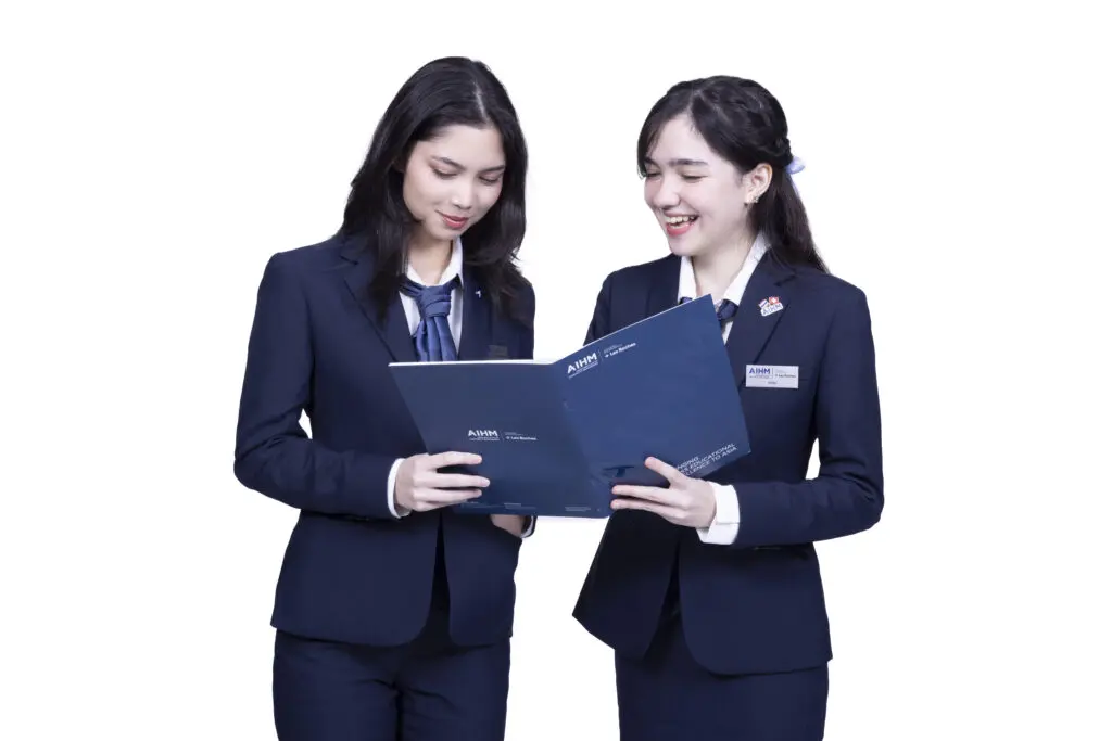 AIHM College student reviews coursework during an NCUK Foundation Year class, demonstrating focused academic study and preparation for international university pathways in Bangkok.