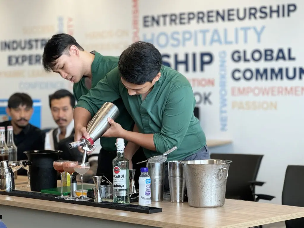 AIHM executive education participants practice professional bartending and mixology during hands-on hospitality training at the Asian Institute of Hospitality & Management in Bangkok, Thailand.
