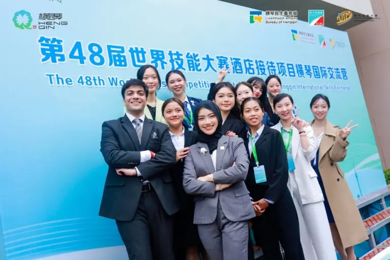 AIHM student and lecturer with international participants at the 48th WorldSkills Hotel Reception Hengqin International Skills Exchange.