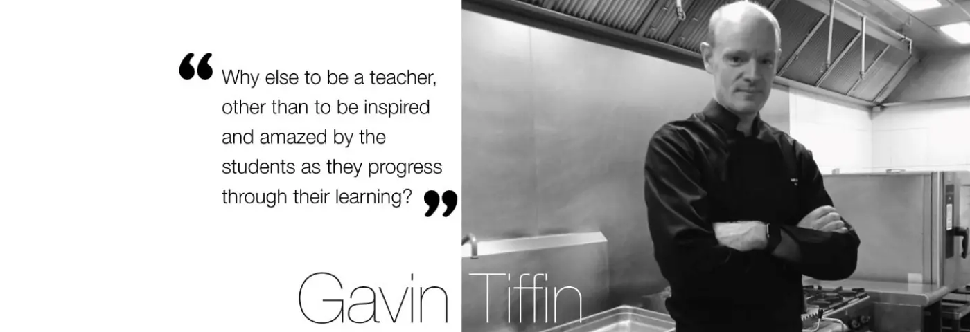 Chef Gavin Tiffin standing in a professional training kitchen beside an inspirational quote about teaching, student learning, and hospitality education at AIHM