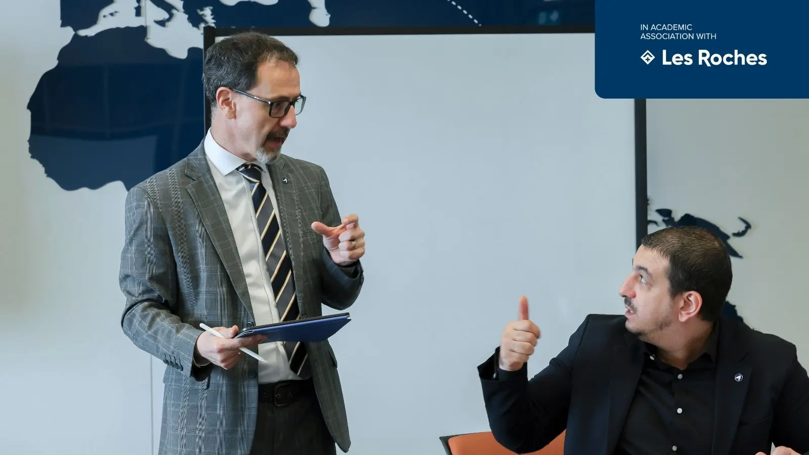AIHM postgraduate diploma students engaging in professional discussion with lecturer, enhancing leadership and decision-making skills in hospitality