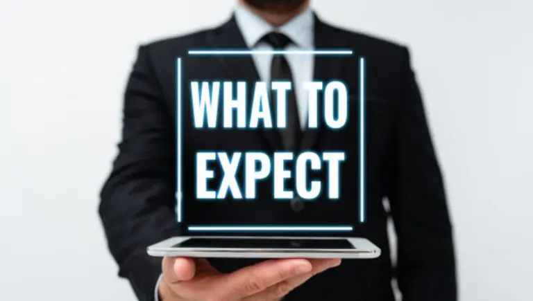 (Blog banner) AIHM What to Expect graphic, businessman holding a tablet with glowing projected text