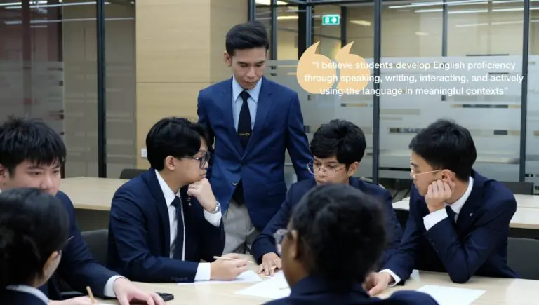 (EBAS lecturer quote header) AIHM EBAS lecturer Maytee Pakdiponpong on developing English proficiency through speaking, writing, and interaction, leading a hospitality student group discussion.