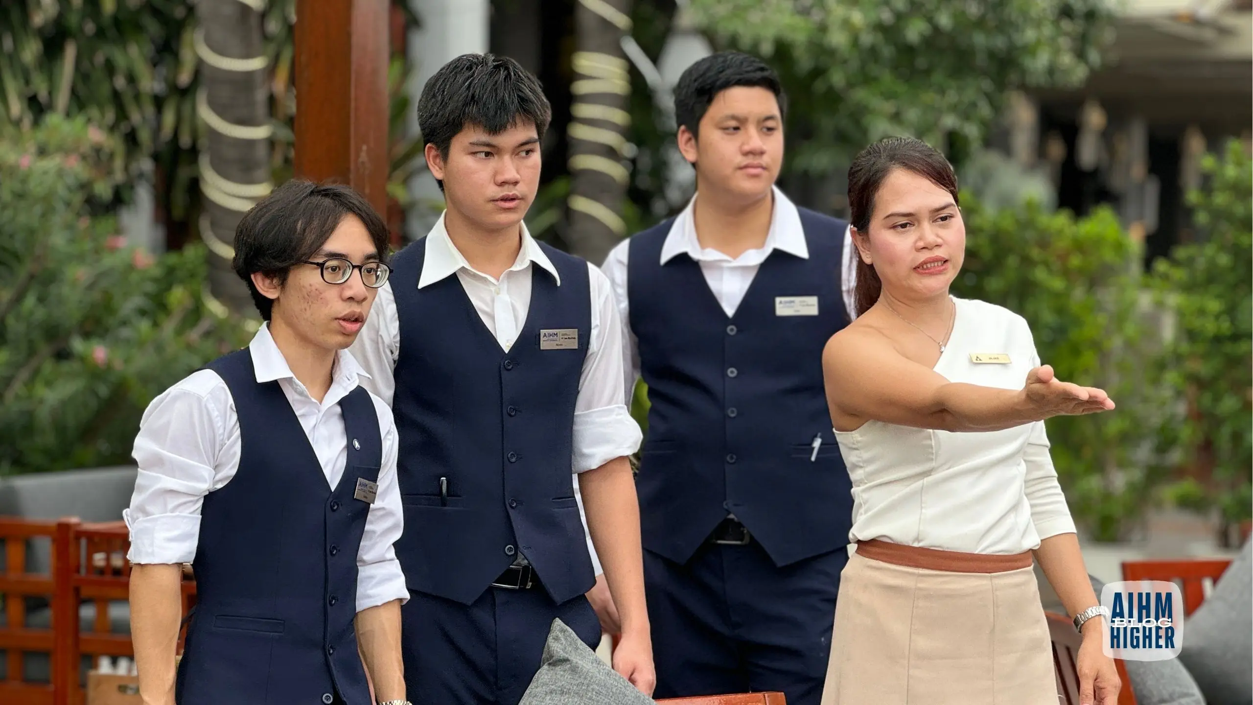 Hospitality students receive hands-on training from an instructor during practical hospitality management learning at AIHM.
