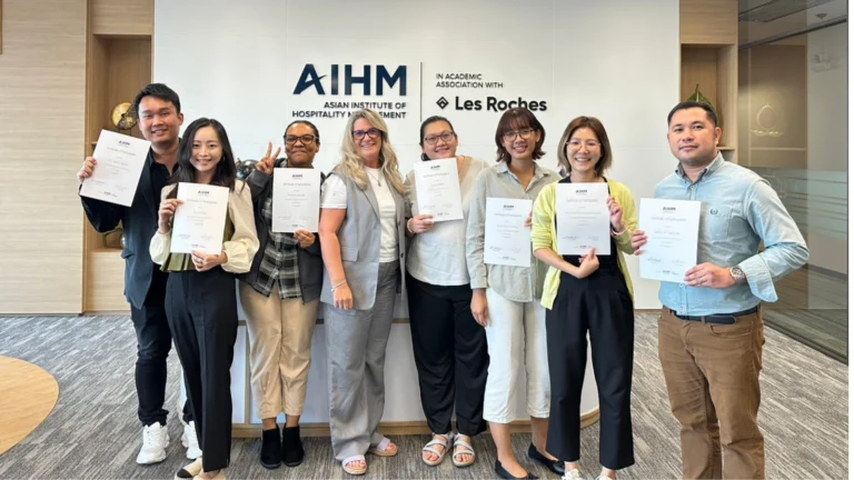 Participants holding certificates after completing Train the Trainer course at AIHM executive education programme