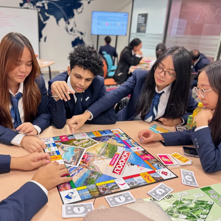 AIHM students play custom hospitality Monopoly game during interactive classroom activity