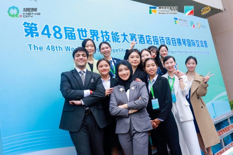 AIHM student and lecturer with international participants at the 48th WorldSkills Hotel Reception Hengqin International Skills Exchange.