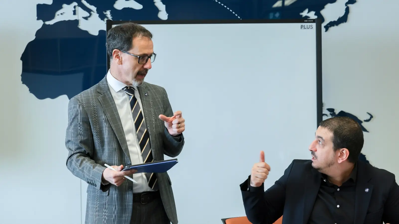 AIHM postgraduate diploma students engaging in professional discussion with lecturer, enhancing leadership and decision-making skills in hospitality