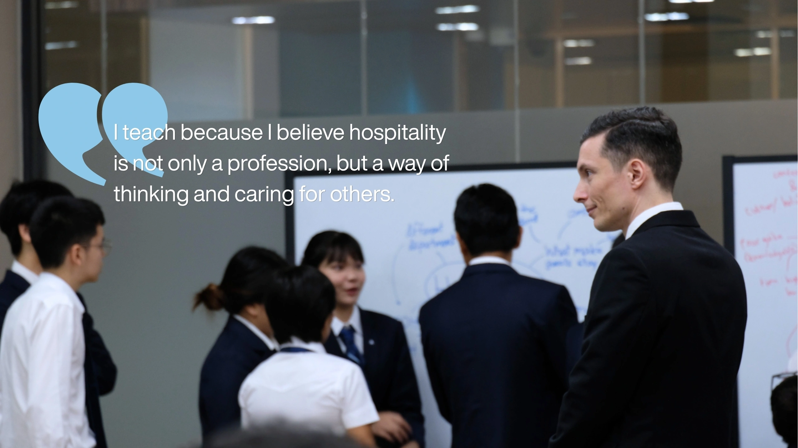 Matteo Emanuele Moiani guiding hospitality students during class discussion at AIHM