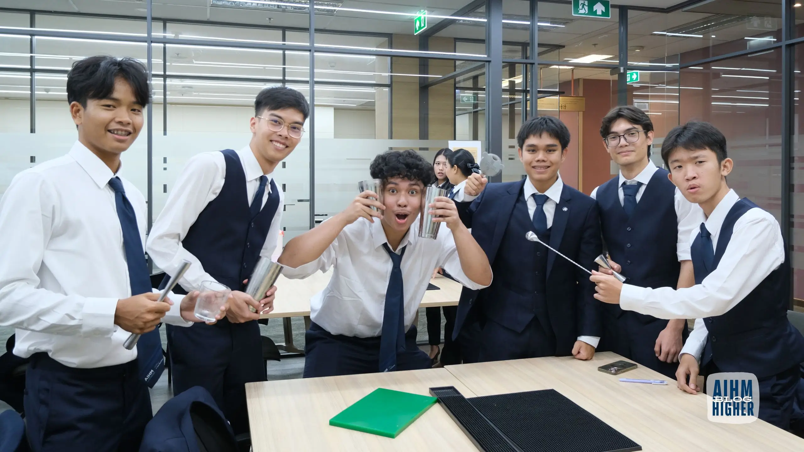 Hospitality students practising bartending skills during hands-on learning at AIHM