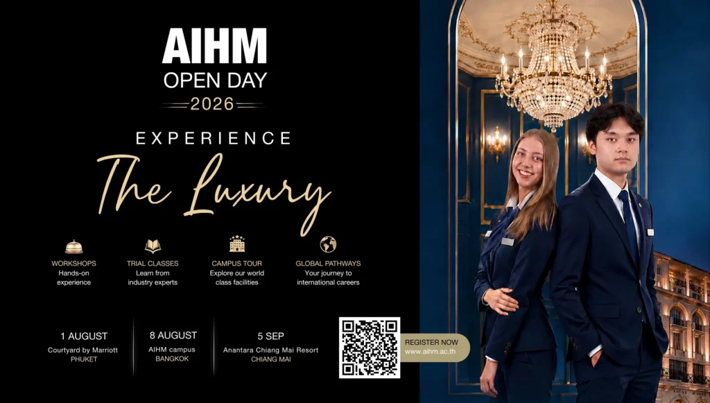 Two AIHM hospitality students in navy uniforms stand beneath an ornate chandelier in a luxury hotel interior, promoting AIHM Open Day 2026 with workshops, trial classes, campus tours, and global pathways.