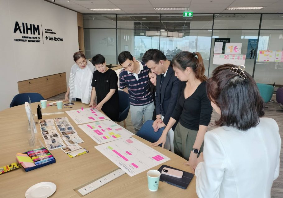 AIHM executive education workshop in Bangkok with professionals collaborating on customer service excellence, analysing service blueprints and improvement strategies in a hands-on hospitality training session.